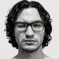 a black and white photo of a man with glasses
