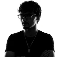 a black and white photo of a man with glasses